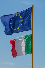 Two flags of Italy and European Union  fluttering in the wind