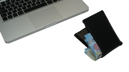 laptop and wallet with money