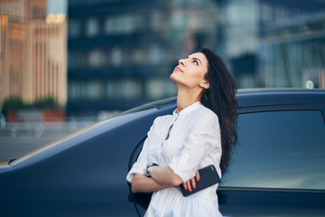 Young woman over modern office facade
