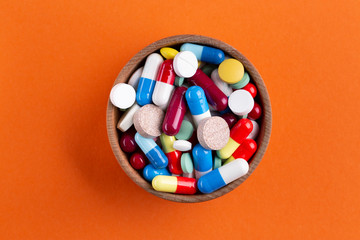 a lot of multi-colored tablets in a plate