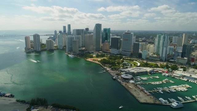 Aerial View Port of Miami and Down Town Showing Cruise Ships  buildings Convention Centers and Arenas beaches Marinas, Rivers  with Boats and car Traffic on a Sunny Afternoon footage in 4K slowmo
