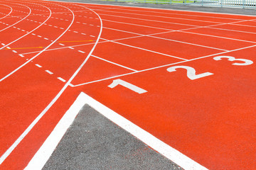 Texture of running racetrack red rubber racetracks in outdoor stadium are 8 track and green grass...