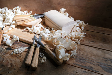 Carpentry tools for wood processing, shavings on a wooden table.