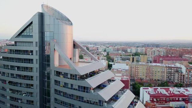 Aerial overview of modern, futuristic building and view of European city and park Turia, shot in Valencia - Spain