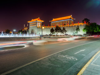 Gate of the citywall of Xian (China) from the outside at night. Some traffic in the front.