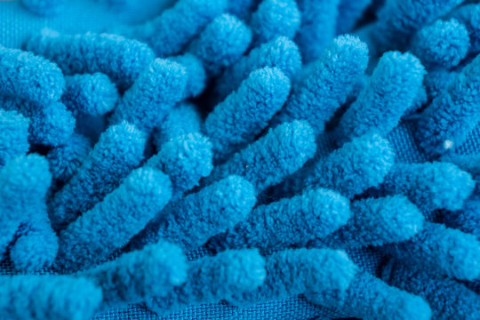 Macro close up of blue chenille microfiber texture for cleaning, trapping dust