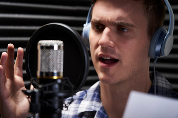 Man In Recording Studio Talking Into Microphone