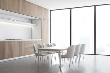 White and wood kitchen corner, counter and table