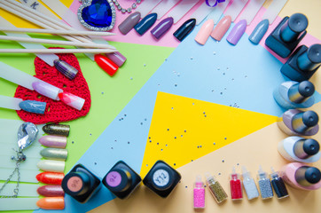 manicure set and a diamond on pastel background top view. Manicure fashion modern bright background. Trendy minimal pop art style and pastel colors