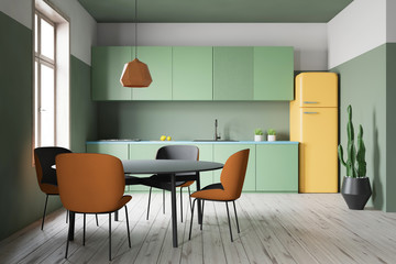 Green kitchen interior with counters and table