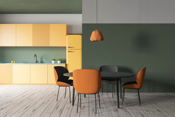 Green kitchen with yellow counters and table