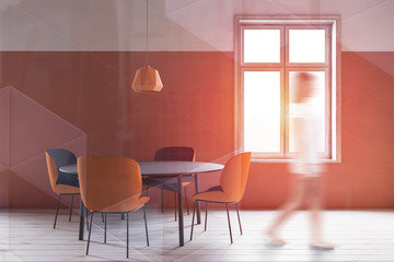 Woman walking in orange dining room