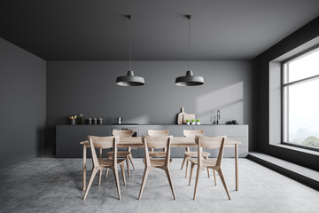 Gray kitchen interior with wooden table