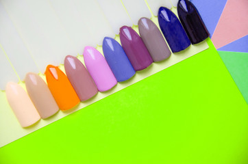 Examples of nails tips on pastel background top view. Manicure fashion modern bright background. Trendy minimal pop art style and pastel colors