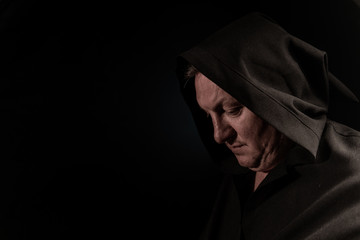 Portrait of a courageous warrior wanderer in a black cloak. Historical fantasy. Halloween.