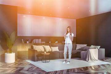 Woman in gray and white living room