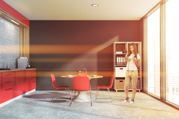 Woman in gray kitchen with bookcase