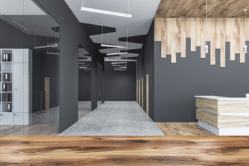 Blurred gray and wooden office hall with reception