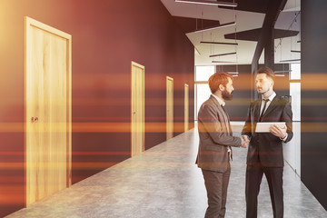 People in gray office hall