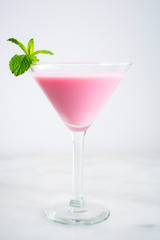 Pink Cocktail with a Mint Garnish