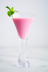 Pink Cocktail with a Mint Garnish