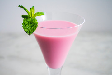 Pink Cocktail with a Mint Garnish