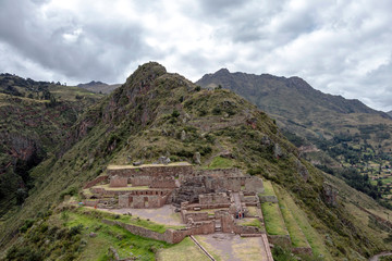 Fototapeta na wymiar Inca ruins in Pisac archeological site surrounded by green peruvian Andes mountains, Sacred valley of the Incas, Peru