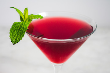 Red Cocktail with Mint Garnish