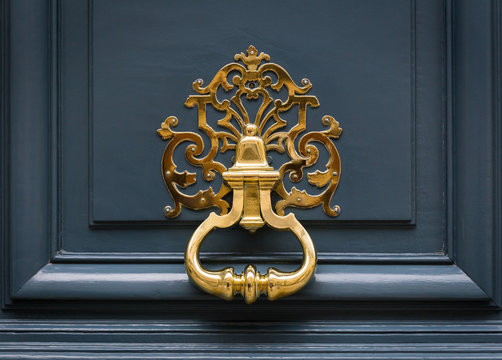 Door knocker made of brass on a front door