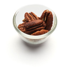 pecan whole nuts in a glass plate