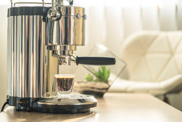 Coffee machine on table in sunlit room, home, office coffee brewing, appliances.