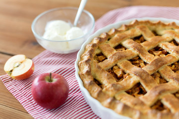 food, culinary and baking concept - apple pie with ice cream on wooden table