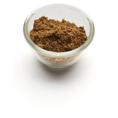 ground cilantro isolated in  a glass plate