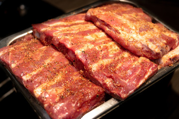 Pieces of ribs are on a tray