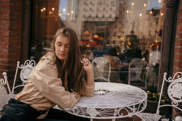 Beautiful girl with long hair walks around the city