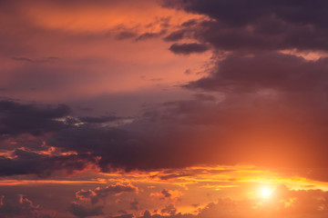 Fototapeta premium Beautiful epic sunset orange pink sky with clouds, sun, sunlight