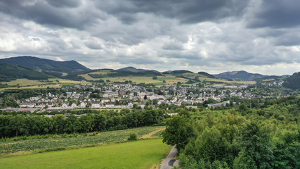Aerial view of Olsberg Bigge, North Rhine Westphalia, Germany. In July, the trees and pastures are...