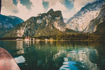 Papier peint photo Le salon View to St. Bartholomew's Church and mountains from a boat on the Koenigssee lake, Germany  © Maria