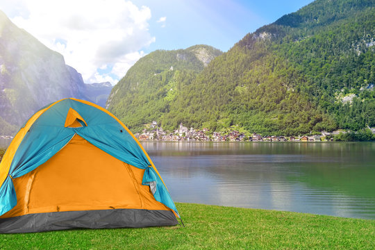 Bright camping tent at riverside near mountains Stock Photo | Adobe Stock