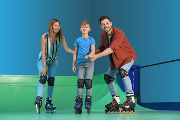 Parents teaching their son roller skating at rink