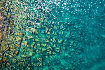 Aerial view of rocky stones in the sea