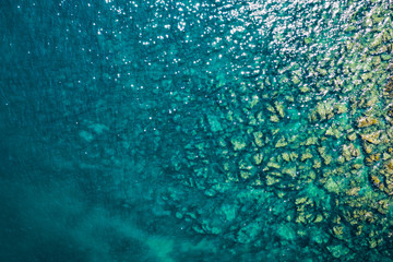 Aerial view of rocky stones in the sea