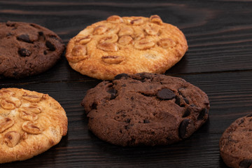 Chocolate cookies on wooden table. Homemade food on wooden background