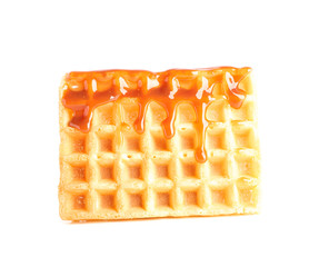 Belgian waffle under caramel topping isolated on white background