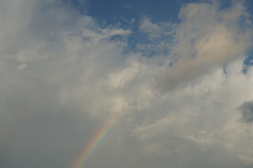Fototapeta na wymiar Rainbow and Clouds with Blue Sky