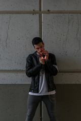 Young man smoking in a tunnel