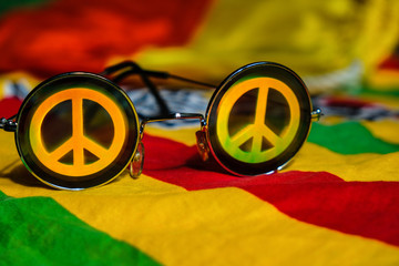 Vintage sunglasses with a symbol of pacifist motion on a rainbow colored scarf.