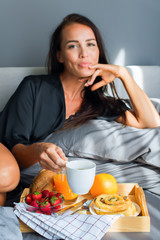 Breakfast bed for holiday young beautiful brunette