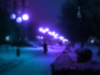 A blurred image of an evening winter alley as background.