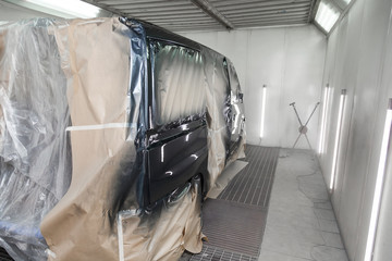 The car after the accident in the camera for car body repair is partially covered with paper and...